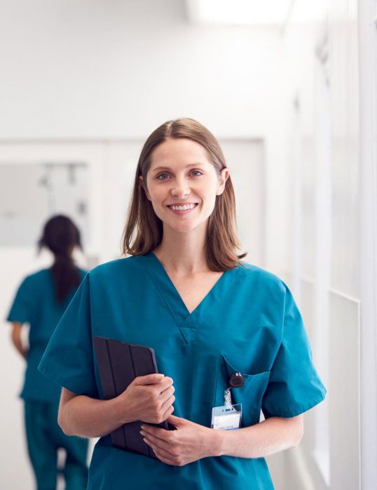 portrait-of-smiling-female-doctor-wearing-scrubs-HZ79GZQ-1.jpg