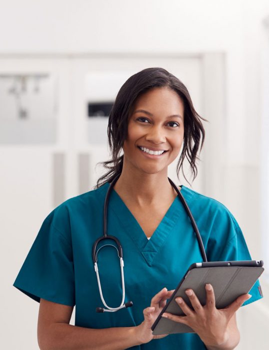 portrait-of-smiling-female-doctor-wearing-scrubs-KLLFEZS-1.jpg